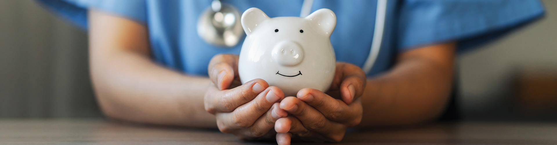 medical doctor holding a piggy bank